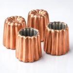 Canele Copper Moulds, 55 mm, Set of Four, shown on a plain studio background