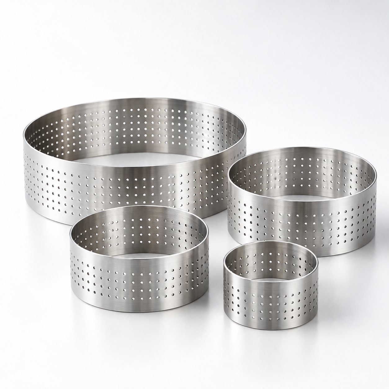 Perforated Tart Ring Set, 8, 10 and 20 cm, shown from a low three quarter angle