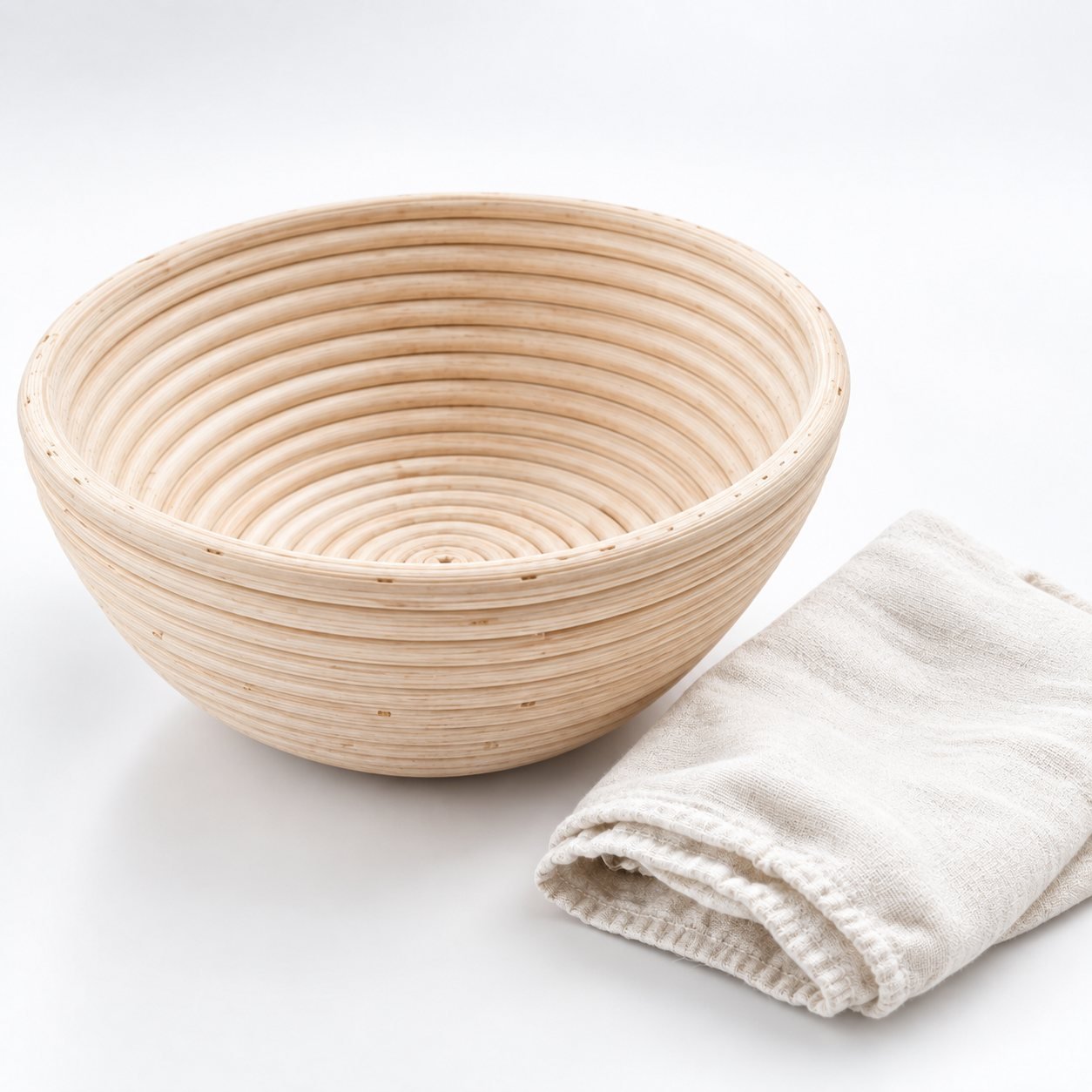 Round Banneton Proofing Basket, 22 cm, with Liner, shown from a low three quarter angle